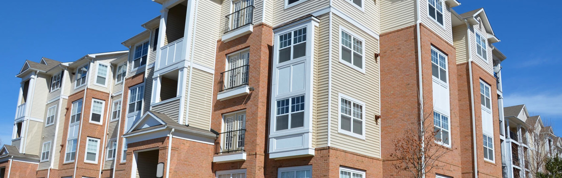 A building with many windows and doors on the side.