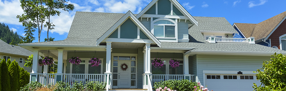 A house with flowers in front of it.