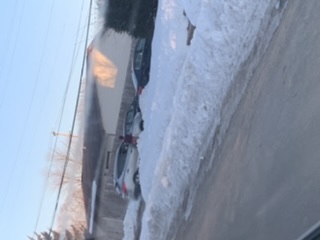 A car is driving on the road in the snow.