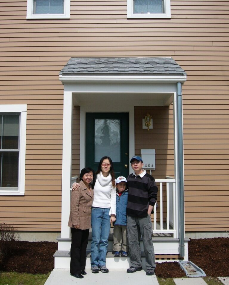 A family standing in front of their home.